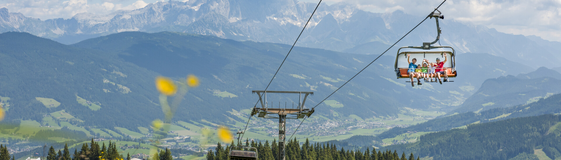 Chairlift in Summer in Flachau  Family on lift in snow space region in summer
